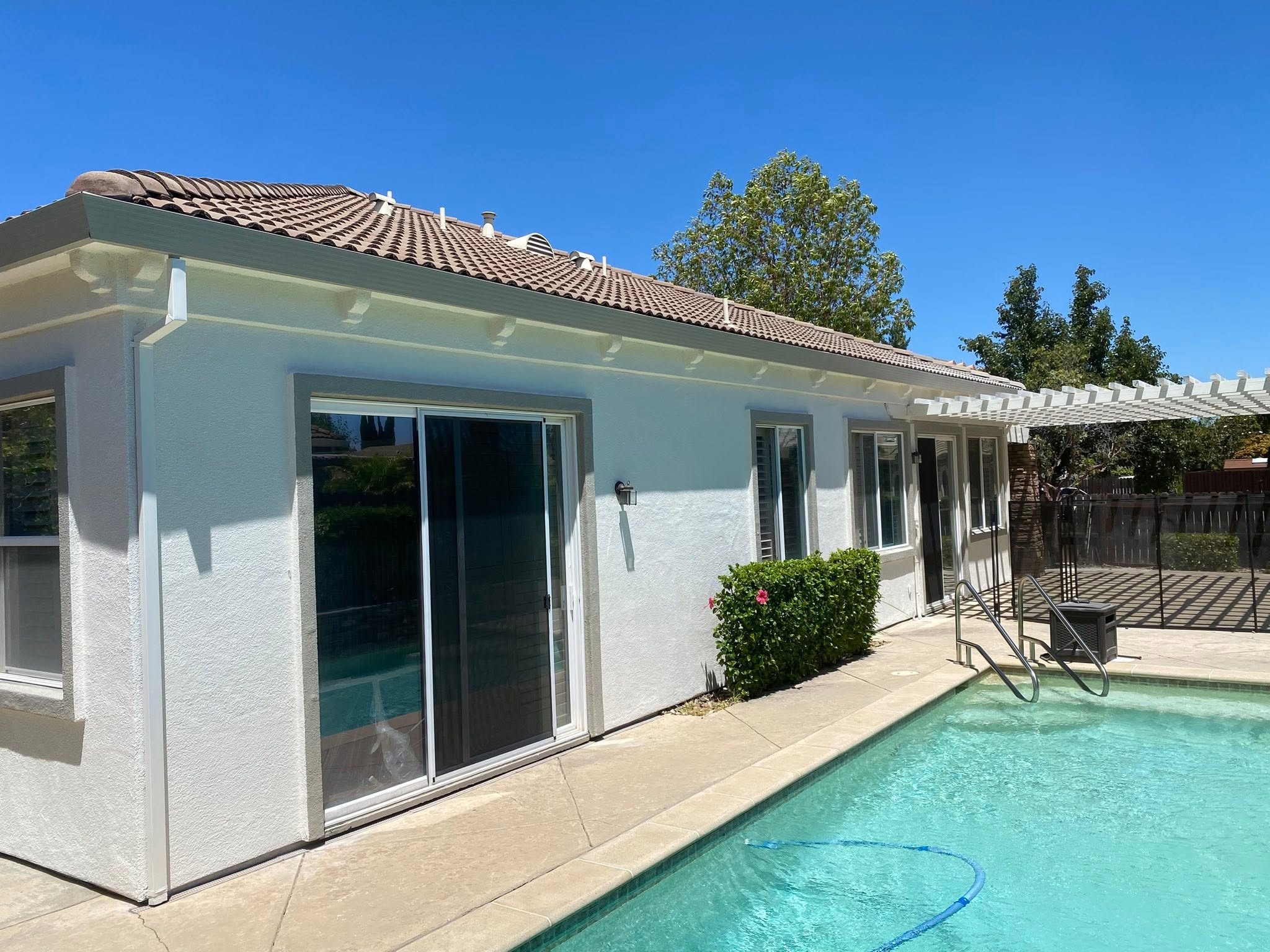 Home backyard exterior white stucco repaint with pool