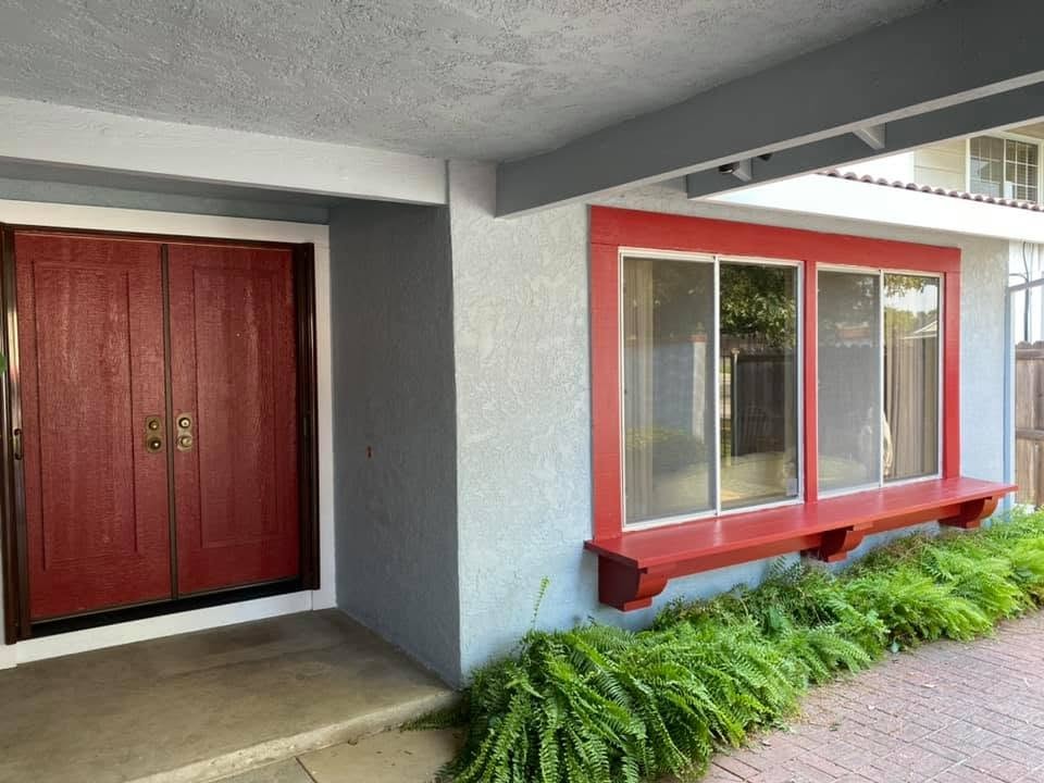 Exterior entryway with bold red door and trim